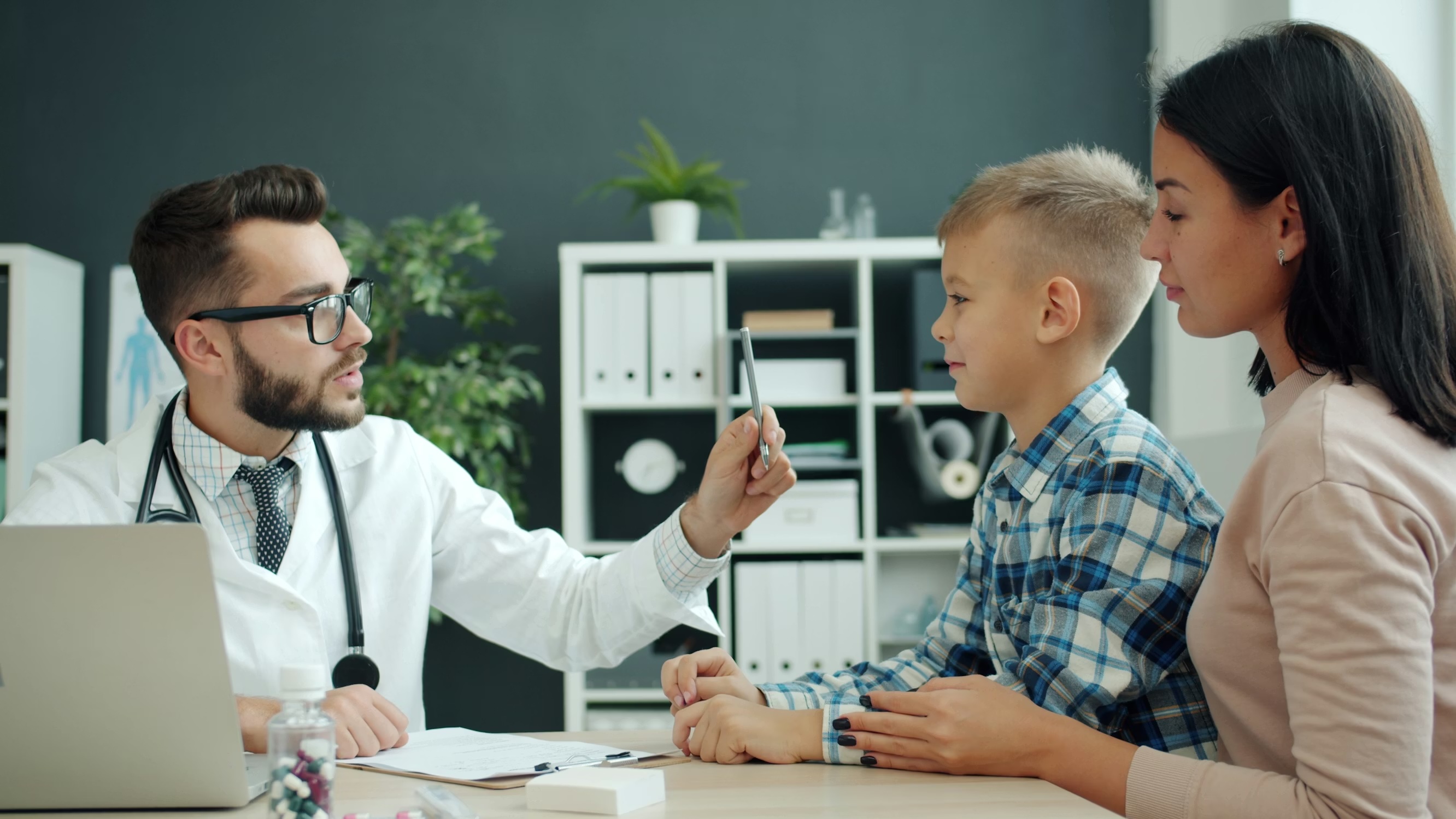 Pediatrician examining a young patient